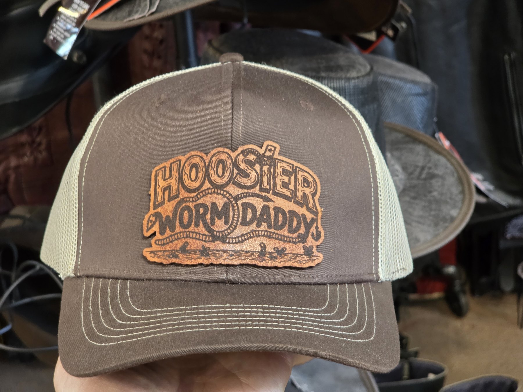 Brown trucker hat with a Hoosier Worm Daddy leather patch
